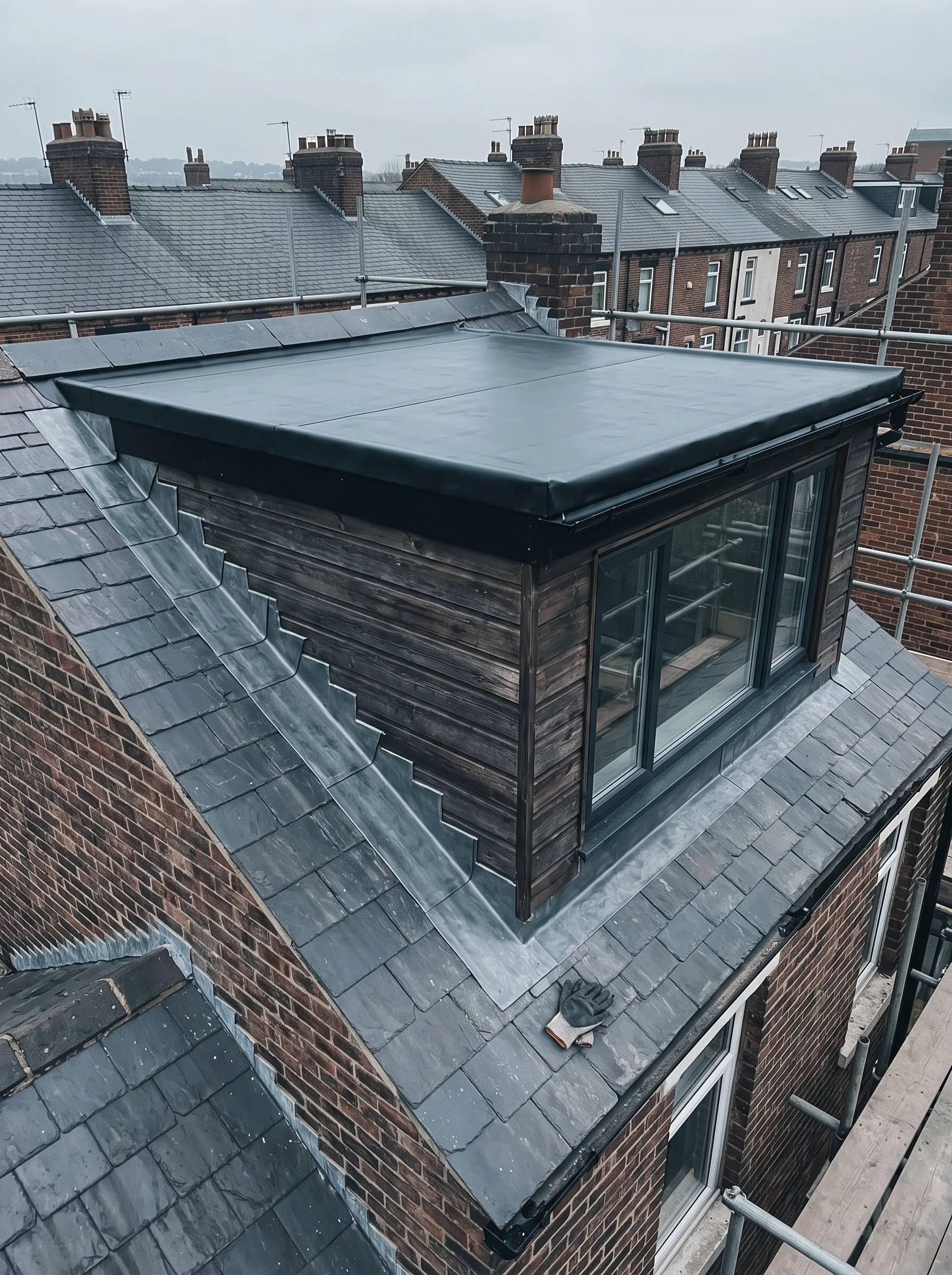 Dormer with a new rubber roof and stepped lead flashings against a slate pitch